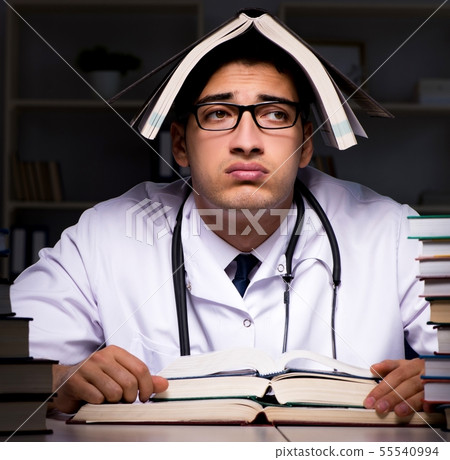 Medical student preparing for university exams at night 55540994