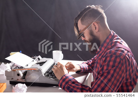 People and technology concept - World day of the writer, handsome man with glasses, dressed in plaid People and technology concept - World day of the writer, handsome man with glasses, dressed in plaid 55541464