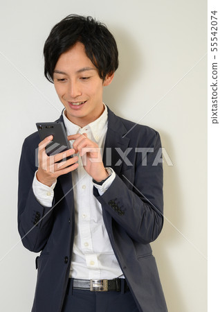 Businessman examining with smartphone Businessman examining with smartphone 55542074