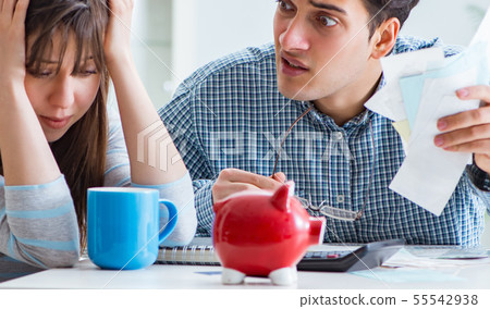 Young couple looking at family finance papers Young couple looking at family finance papers 55542938