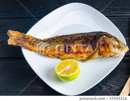 Fried fish served on the plate Fried fish served on the plate 55543318