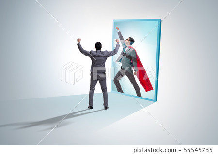 Businessman seeing himself in mirror as superhero Businessman seeing himself in mirror as superhero 55545735