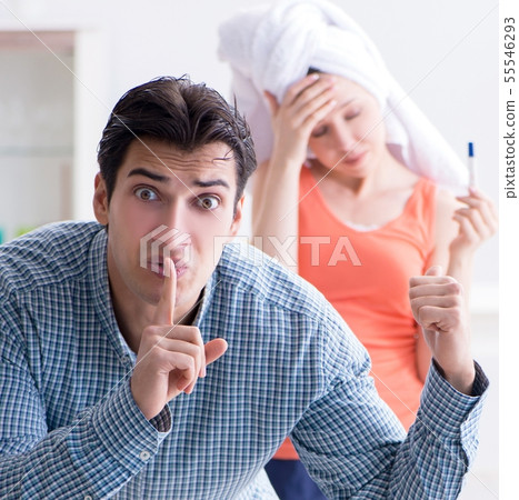 Wife and husband looking at pregnancy test 55546293