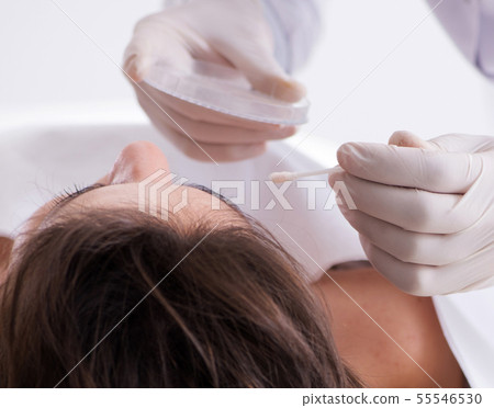 Police coroner examining dead body corpse in morgue 55546530
