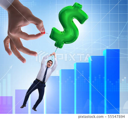 Businessman flying on dollar sign inflatable balloon over financ Businessman flying on dollar sign inflatable balloon over financ 55547894