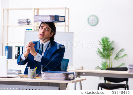 Young businessman sitting and working in the office Young businessman sitting and working in the office 55548425
