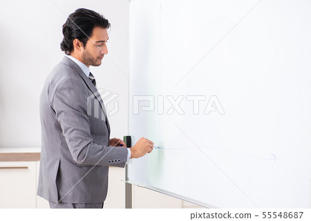 Young handsome businessman in front of whiteboard 55548687