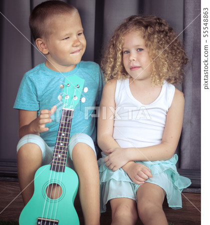 Portrait of a cute kids with ukulele Portrait of a cute kids with ukulele 55548863