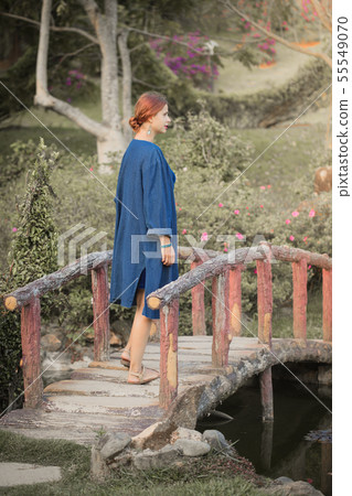 Beautiful woman on a bridge in the park 55549070
