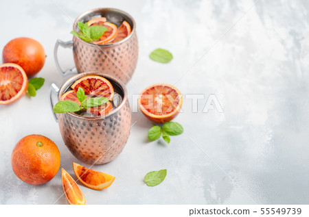 Blood orange Moscow mule alcohol cocktail. 55549739