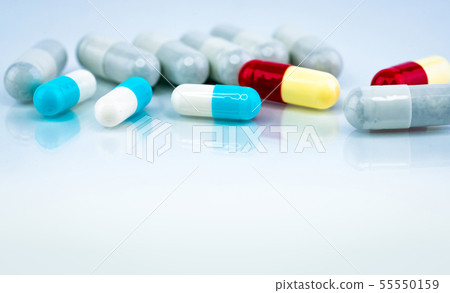 Colorful capsule pills on white background. 55550159