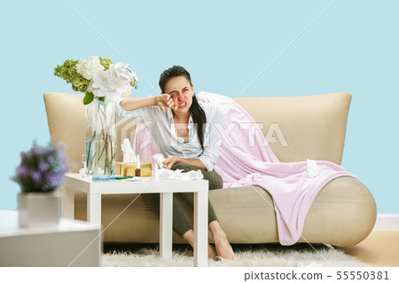 Young woman suffering from hausehold dust or seasonal allergy. Young woman suffering from hausehold dust or seasonal allergy. 55550381