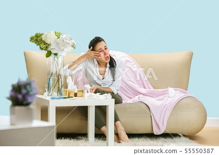 Young woman suffering from hausehold dust or seasonal allergy. 55550387