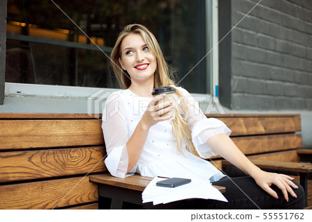 Portrait of young businesswoman use mobile phone while sitting in comfortable coffee shop during Portrait of young businesswoman use mobile phone while sitting in comfortable coffee shop during 55551762
