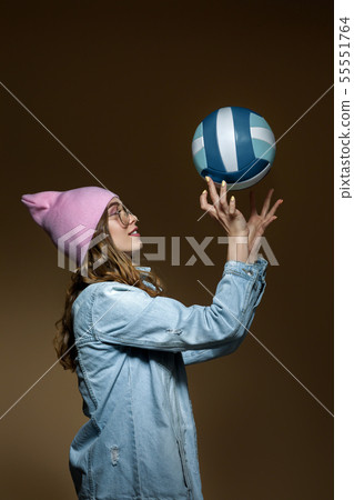 girl in jeans, a pink hat and stylish glasses with a ball girl in jeans, a pink hat and stylish glasses with a ball 55551764