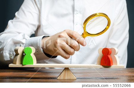 A man with a magnifying glass is looking  55552066