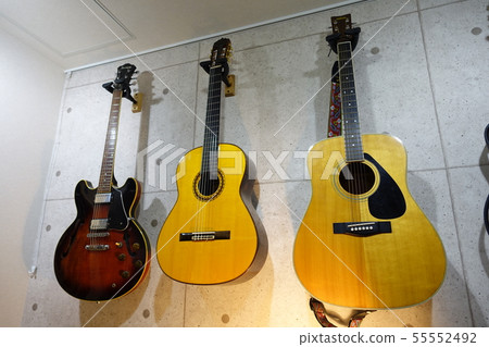 A guitar hung on the wall 55552492