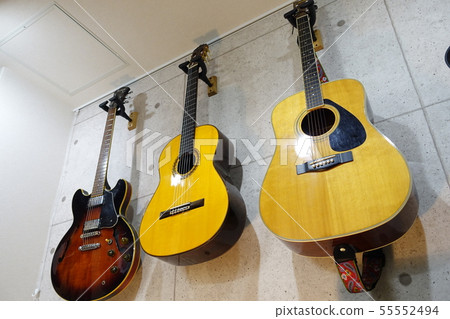 A guitar hung on the wall 55552494