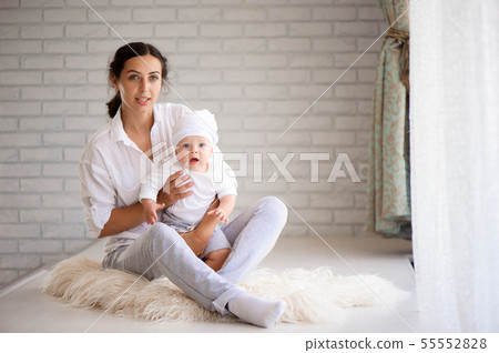 Mom and baby boy in playing in sunny bedroom Mom and baby boy in playing in sunny bedroom 55552828