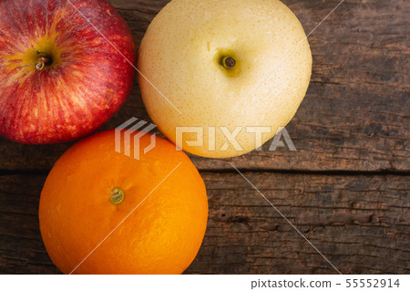 Apple, Orange and Asian Pear on Wooden Table. 55552914