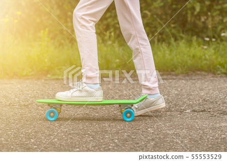 Girl ride skateboard on a sunny day Girl ride skateboard on a sunny day 55553529