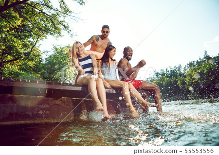 splashing water and laughting on the pier on river 55553556