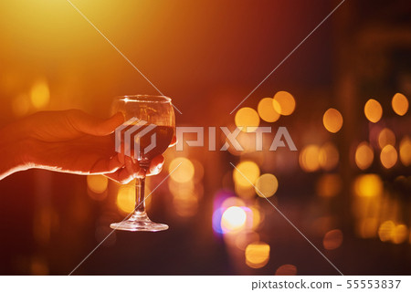 wineglass with wine in woman hand 55553837
