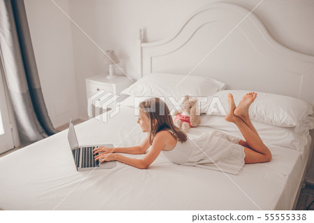 Cute little girl doing homework on laptop 55555338