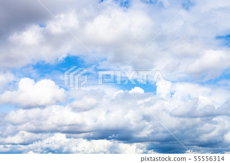 low dense cumulus clouds in blue sky on summer day 55556314