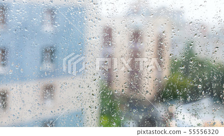 raindrops on window and blurred appartment houses 55556320