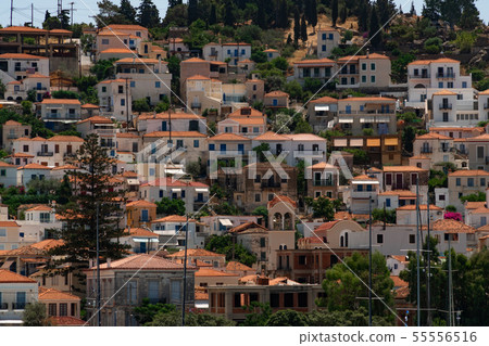 View to white houses with red roofs of Poros town, Saronic islands, Poros island, Greece. Pattern View to white houses with red roofs of Poros town, Saronic islands, Poros island, Greece. Pattern 55556516