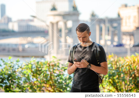 Man tourist with smartphone and backpack in Europe street. Man tourist with smartphone and backpack in Europe street. 55556543
