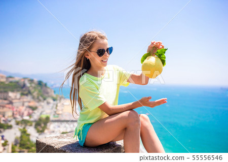 Big yellow lemon in hand in background of mediterranean sea and sky. Big yellow lemon in hand in background of mediterranean sea and sky. 55556546