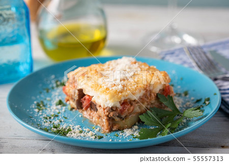 greek moussaka on blue plate in white wooden greek moussaka on blue plate in white wooden 55557313