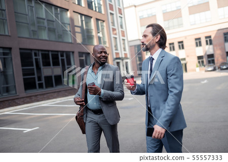Business partners walking to the office together in the morning Business partners walking to the office together in the morning 55557333