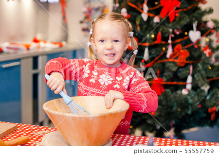 Adorable little girl baking Christmas gingerbread cookies 55557759