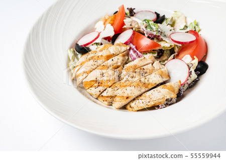 grilled chicken with vegetables on the white plate 55559944