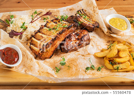grilled ribs with potatoes and sauce 55560478