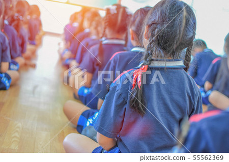 School students do meditation in class. 55562369