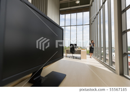 Side view of computer, there is businesswoman.. 55567185