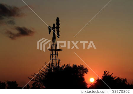 Kansas Windmill Silhouette Sunset with tree's 55570802