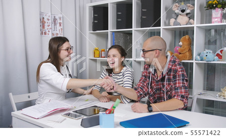 Friendly doctor writes out a teenager after his illness and hugs her goodbye. Father and daughter 55571422