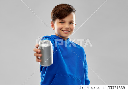 smiling boy in blue hoodie holding can drink 55571889