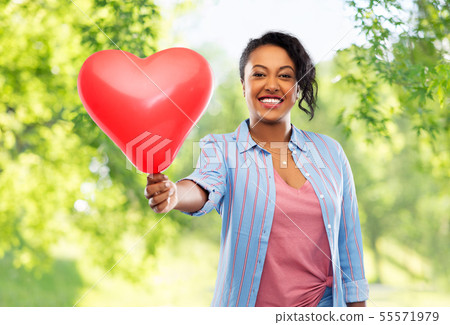 african american woman with heart-shaped balloon 55571979