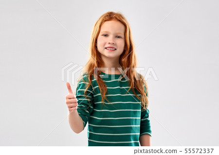 smiling red haired girl showing thumbs up 55572337