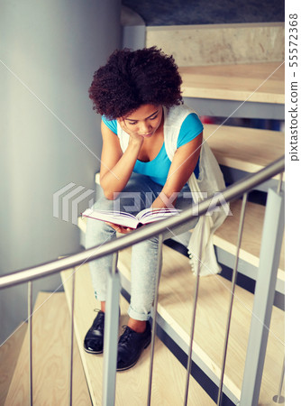 african student girl reading book on stairs african student girl reading book on stairs 55572368