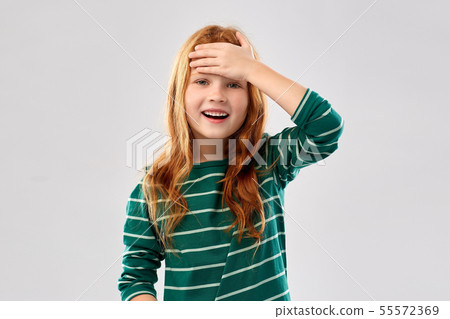 smiling red haired girl holding to her head smiling red haired girl holding to her head 55572369