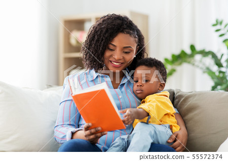 african american mother with book and baby at home 55572374