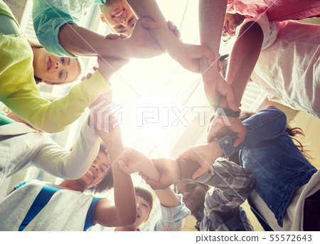 group of international students holding hands group of international students holding hands 55572643