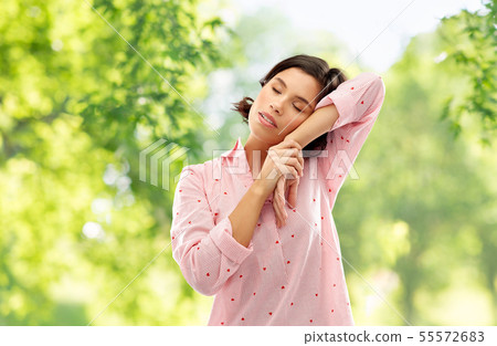 woman in pajama napping over natural background woman in pajama napping over natural background 55572683